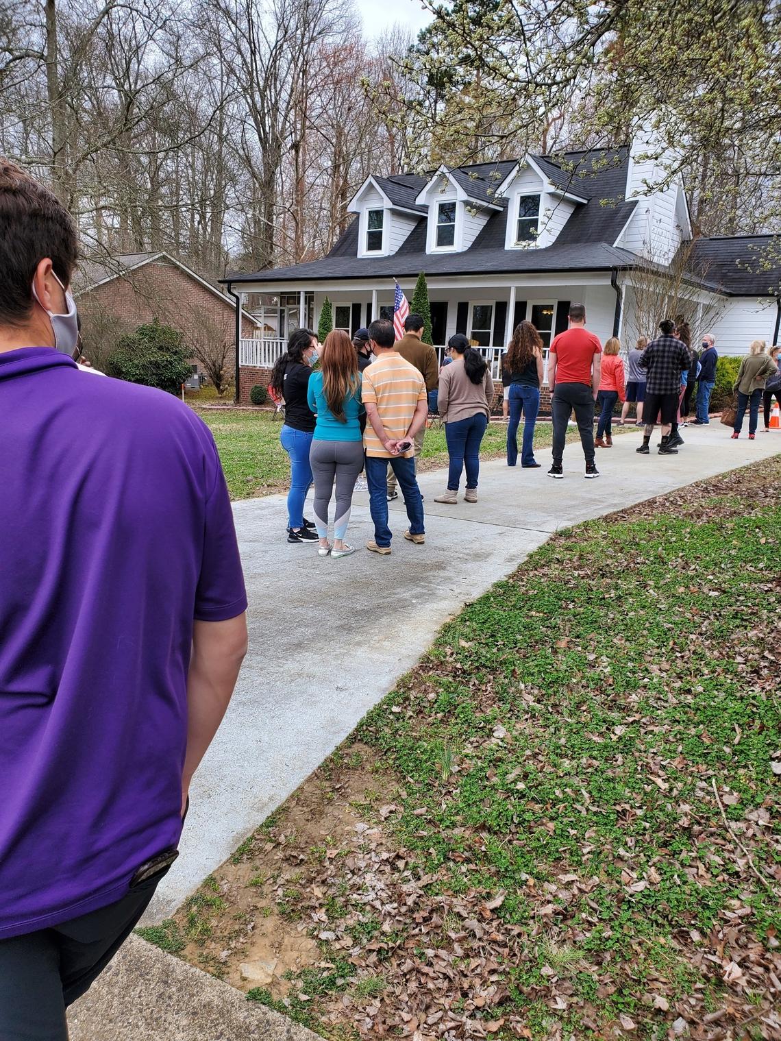A crowd of people waited to get into an open house in Charlotte in 2021. Lines out the door became the norm in a fiercely competitive market that is finally cooling down, local real estate agents say.