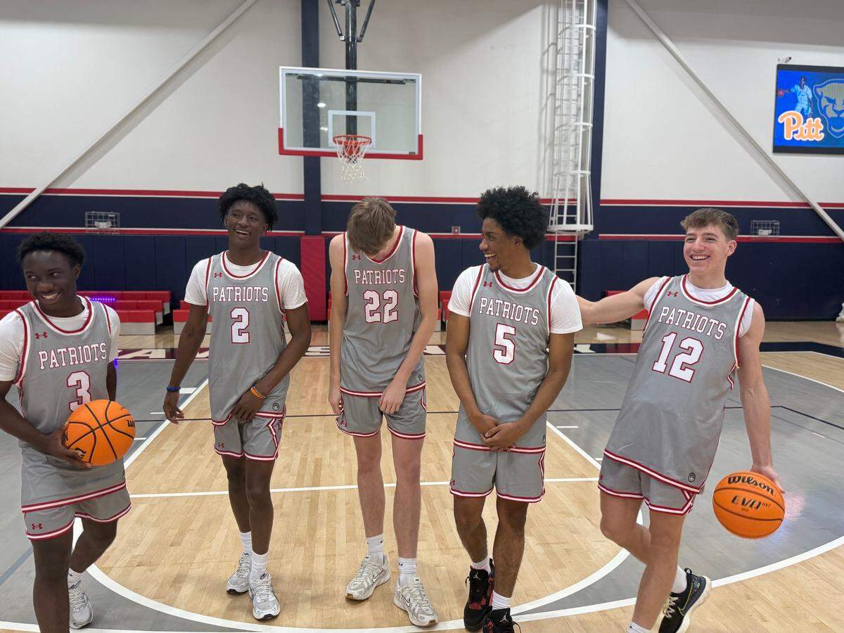 Davidson Day’s 2024-25 boys’ basketball starters laugh during an Observer photoshoot