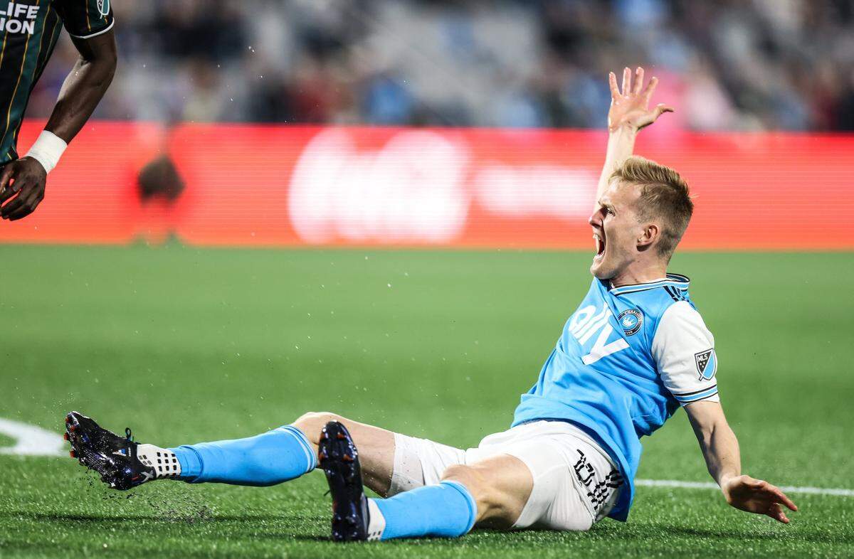 Charlotte FC Karol Swiderski throws his hands up on the ground during the match against LA Galaxy at the Bank of America Stadium in Charlotte, N.C., on Saturday, March 5, 2022.