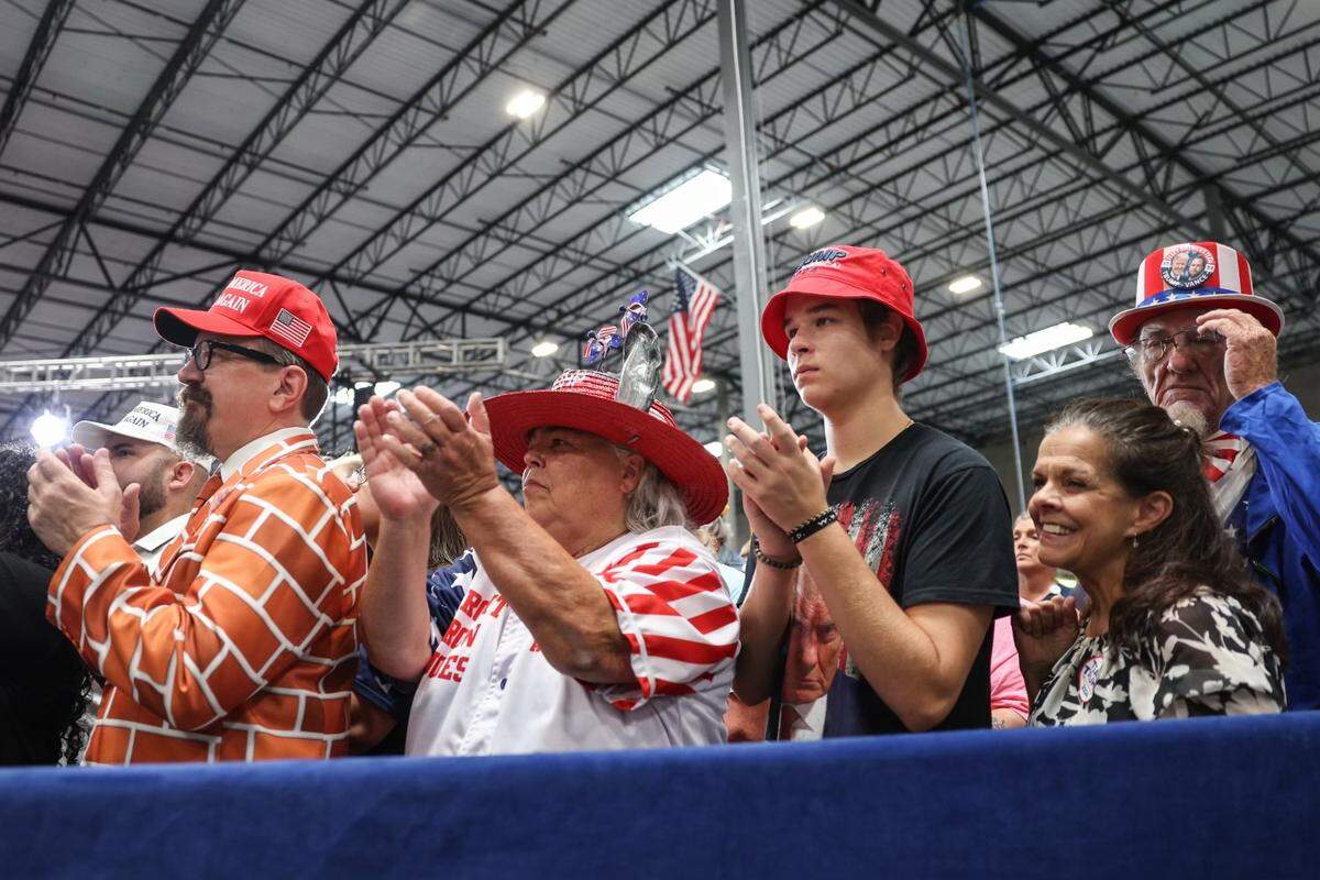 Supporters welcome former President Donald Trump at a campaign rally inside the Mosack Group manufacturing warehouse in Mint Hill, NC on Wednesday, September 25, 2024.