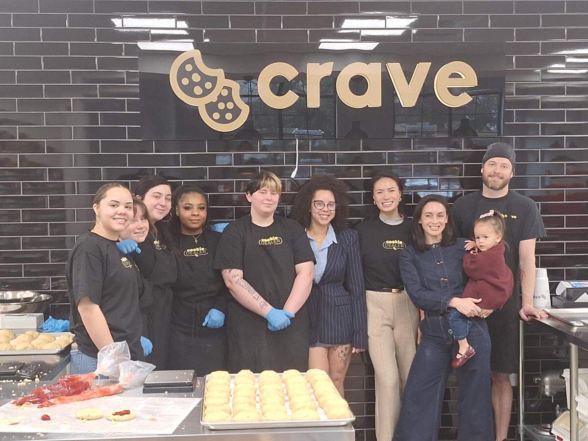 Shown at Crave Cookies in Mooresville on Wednesday, Feb. 18, 2026, are, from left, baker Teja Turner, front-of-house workers and decorators Kaylee Sharpe, Marley Solano, Daya Wallace and Salem Elliott, owners Nekolle Eddie, Samonia “Sam” Ngo and Macie Mincey, and trainer Johnathan Deesing.