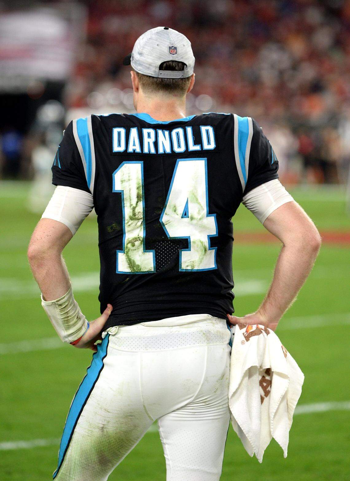 Grass stains mark Carolina Panthers quarterback Sam Darnold’s jersey as he stands on the sideline in the closing moments of 41-17 loss to the Tampa Bay Buccaneers at Raymond James Stadium in Tampa, Fl. on Sunday, January 9, 2022.