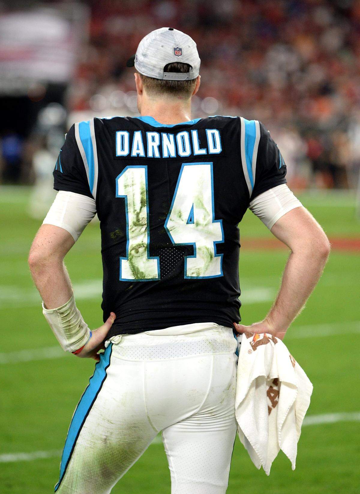 Grass stains mark Carolina Panthers quarterback Sam Darnold’s jersey as he stands on the sideline in the closing moments of 41-17 loss to the Tampa Bay Buccaneers at Raymond James Stadium in Tampa, Fl. on Sunday, January 9, 2022.