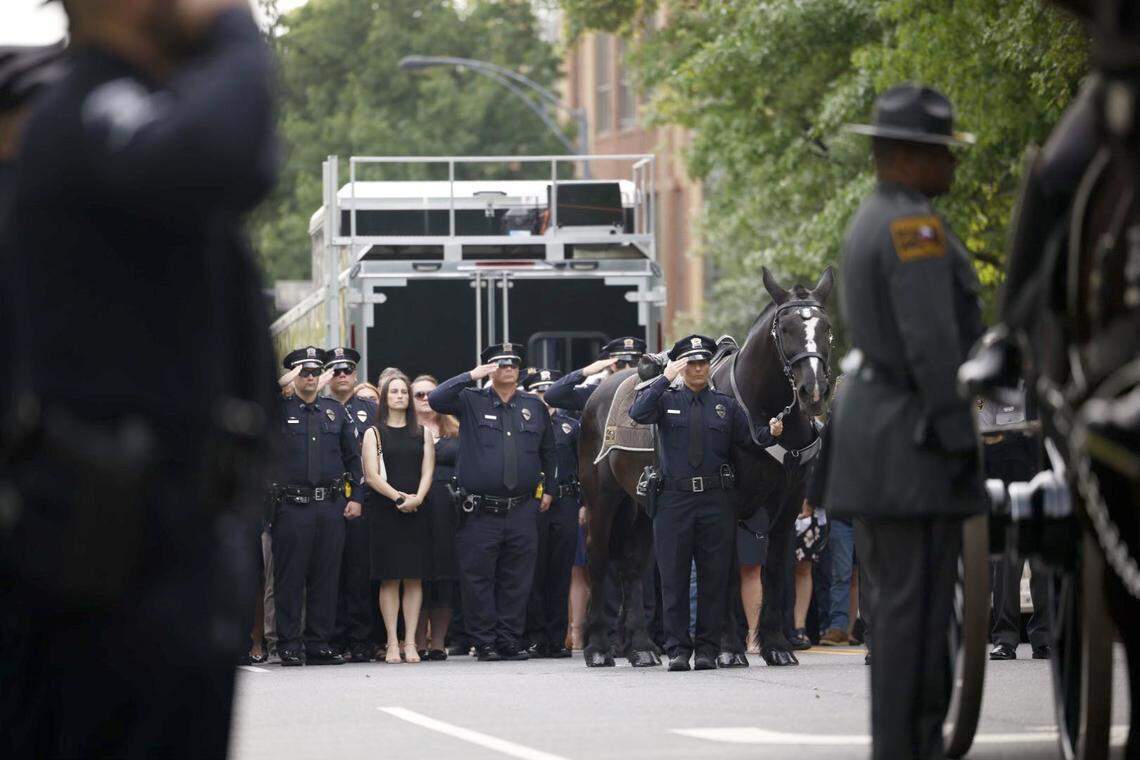 Law officers line up for the processional of Charlotte-Mecklenburg Police Officer Eyer on Friday to First Baptist Church on Friday, May3, 2024. Officer Eyer was killed while serving a warrant in east Charlotte on Monday, April 29, 2024