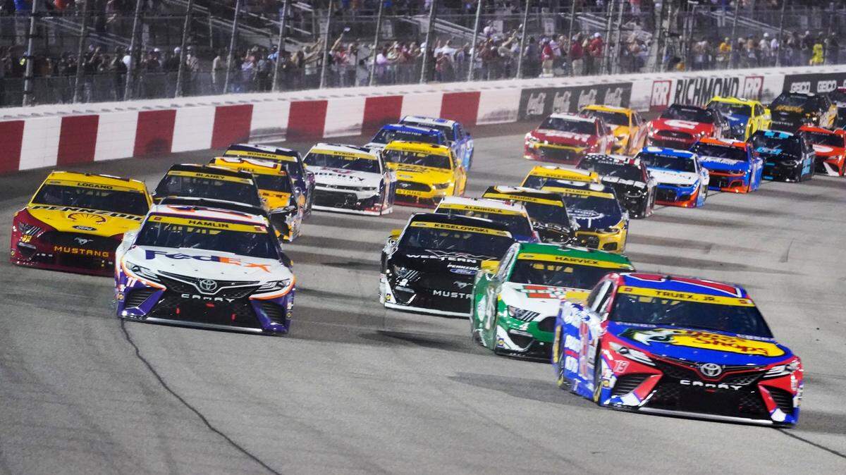 Denny Hamlin (11) and Martin Truex Jr., (19) lead the field st the start of the NASCAR Cup series auto race in Richmond, Va., Saturday, Sept. 11, 2021. (AP Photo/Steve Helber)