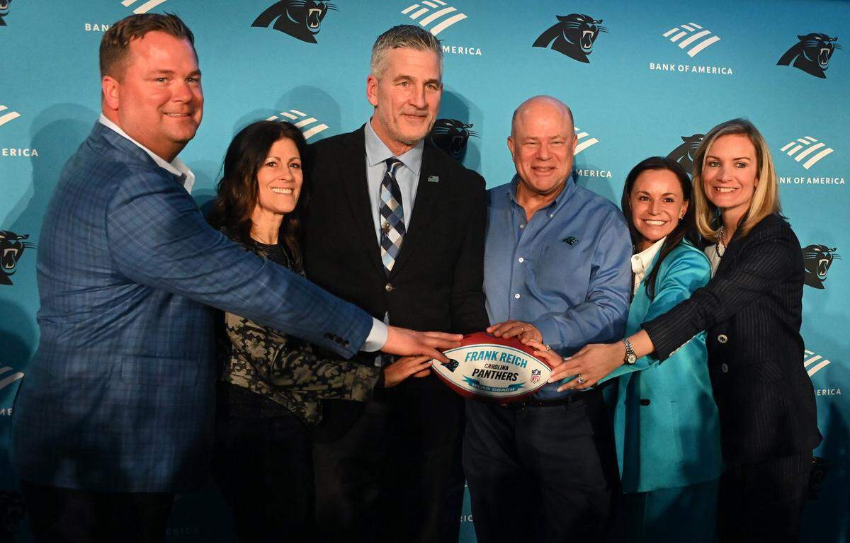 (L-R) Carolina Panthers general manager Scott Fitterer, Linda Reich, new Carolina Panthers head coach Frank Reich, team owners David and Nicole Tepper and team president Kristi Coleman pose for photographs following Frank Reich’s introductory press conference at Bank of America Stadium on Tuesday, January 31, 2023.