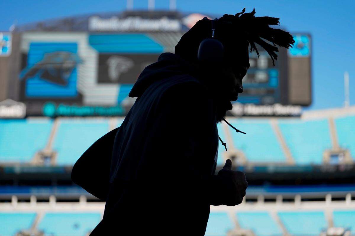 Carolina Panthers quarterback Cam Newton warms up before an NFL football game against the Atlanta Falcons Sunday, Dec. 12, 2021, in Charlotte, N.C. (AP Photo/Jacob Kupferman)