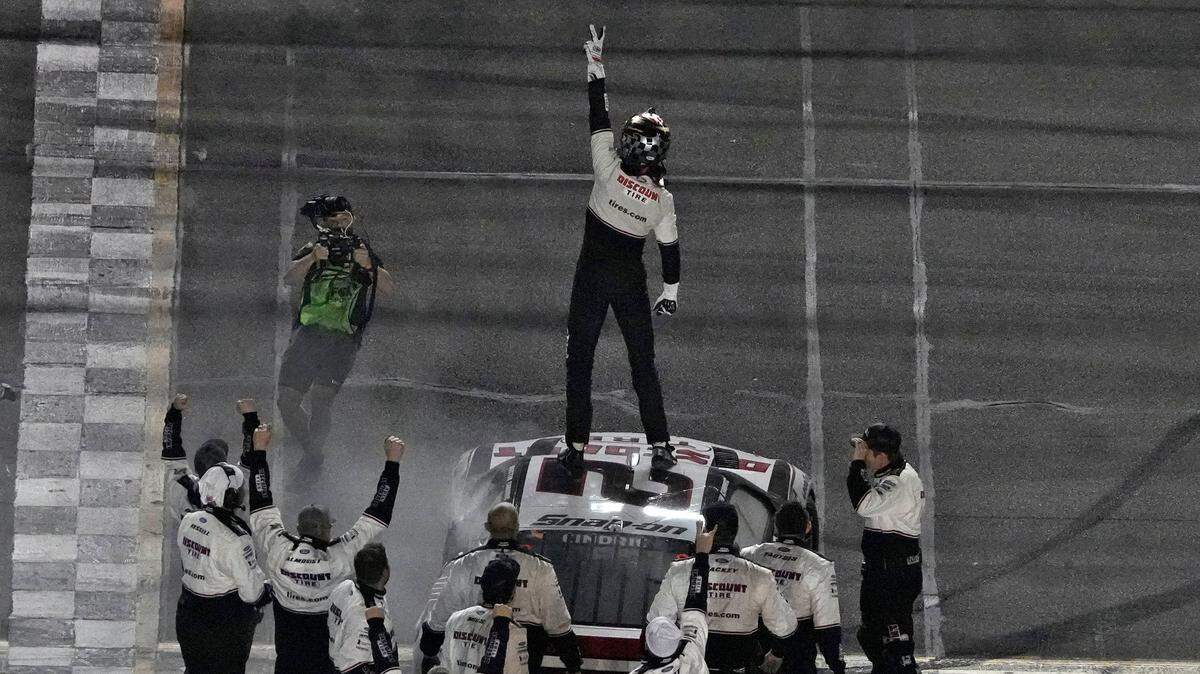 Austin Cindric celebrates on top of his car after winning the NASCAR Daytona 500 auto race Sunday, Feb. 20, 2022, at Daytona International Speedway in Daytona Beach, Fla. (AP Photo/Chris O’Meara)