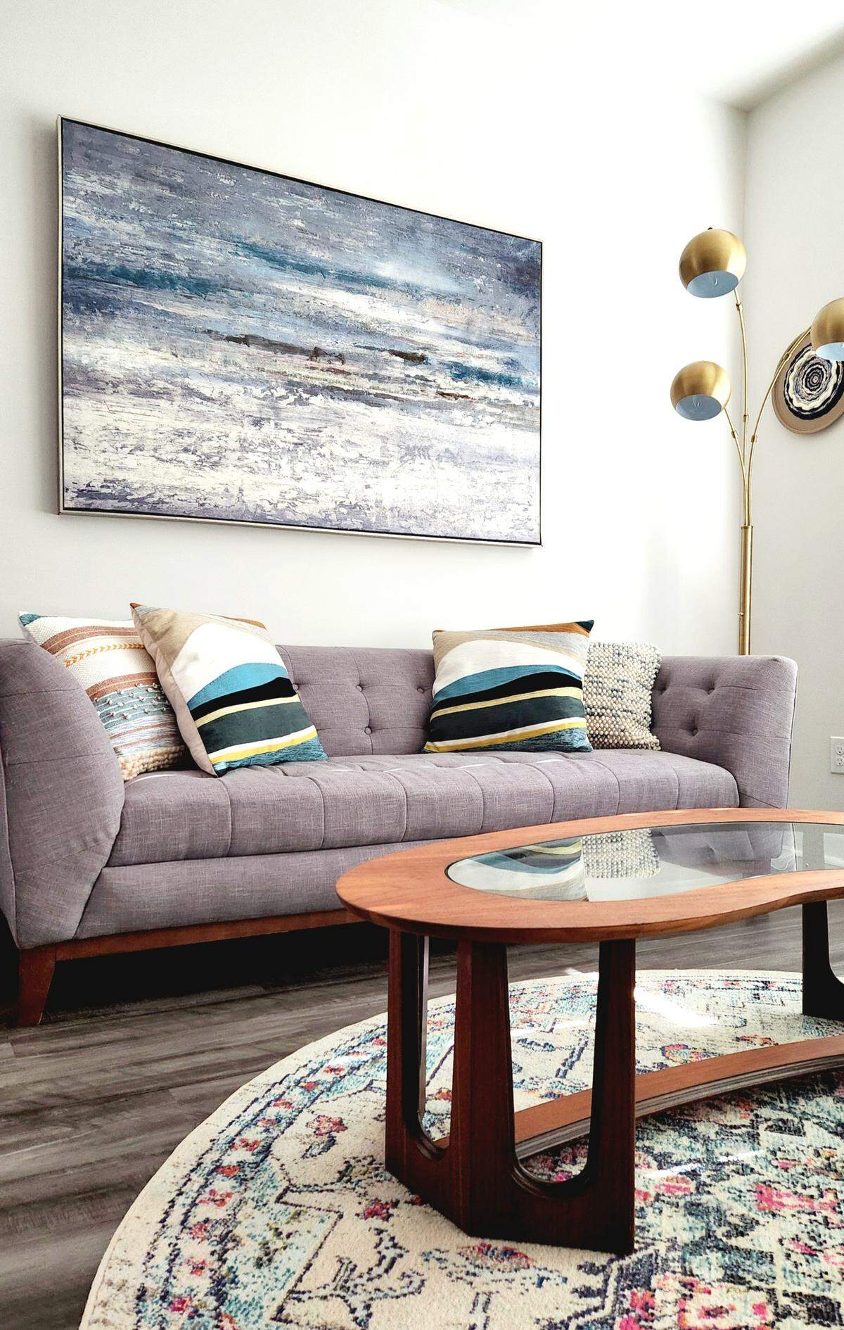 Sarah Ramberg of Belmont, who “thrifts for a living,” has furnished her living room with secondhand furniture and decor. The couch was purchased at Habitat ReStore on Wilkinson Boulevard.
