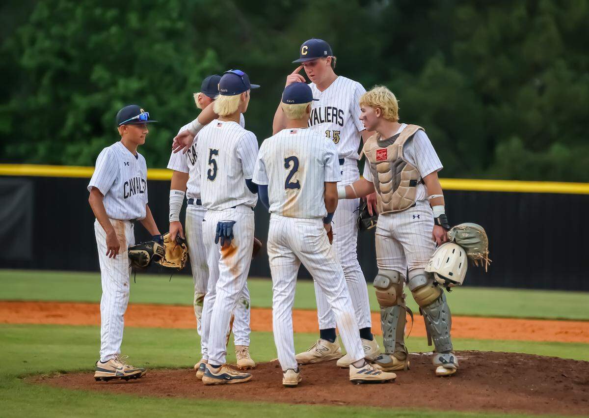 Cuthbertson players huddle on the pitcher’s mound discussing their next move after falling behind West Forsyth by one run at the NCHSAA 4A playoffs at Cuthbertson high school in Waxhaw, NC on May 16th, 2025