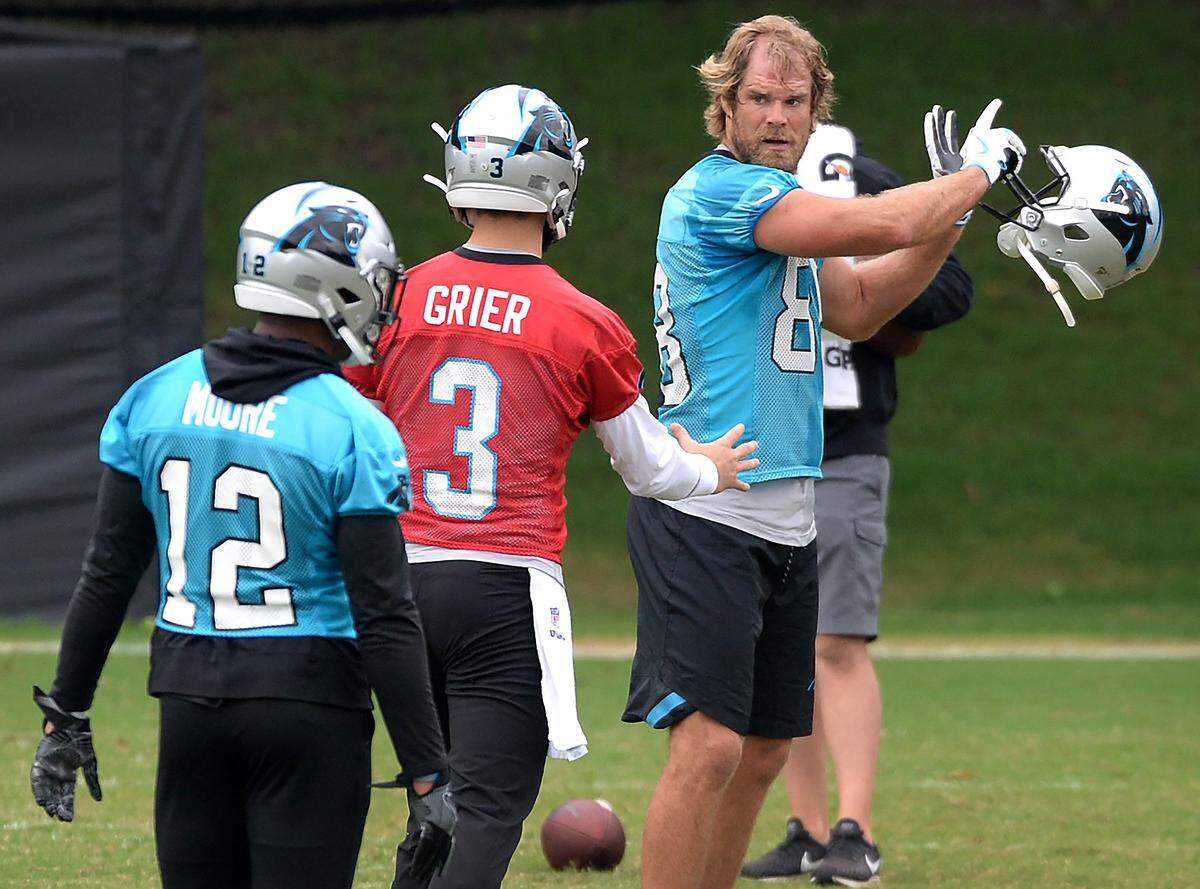 Carolina Panthers tight end Greg Olsen, right, talks with rookie quarterback Will Grier, center, during practice on Thursday, June 13, 2019.