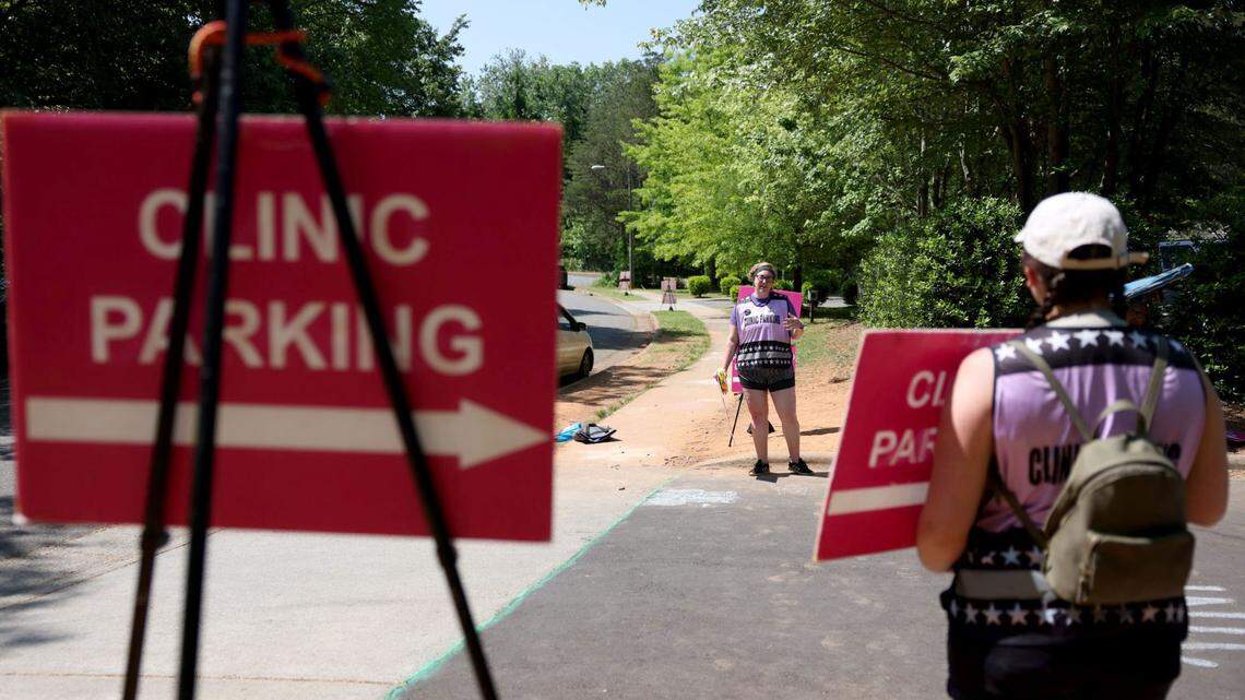 Nicole Fleming, center, volunteers as a clinic defender at A Preferred Women’s Health Center of Charlotte.