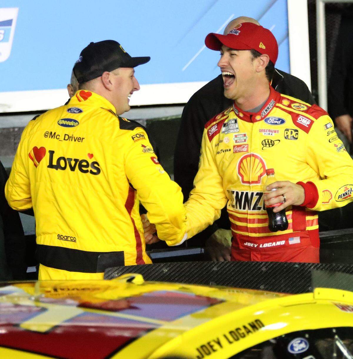 Michael McDowell and Joey Logano share laughs and hand shakes in Victory Lane after Logano beats McDowell for the Daytona 500 pole with McDowell starting second, Wednesday February 14, 2024 at Daytona International Speedway.