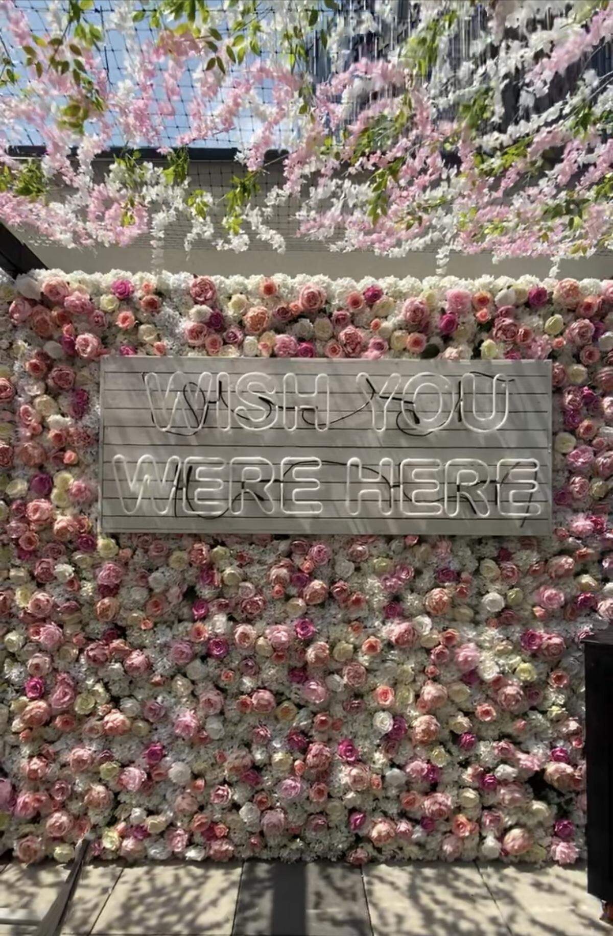 The Novelty House Rooftop bar features a “Wish You Were Here” floral Instagram wall.
