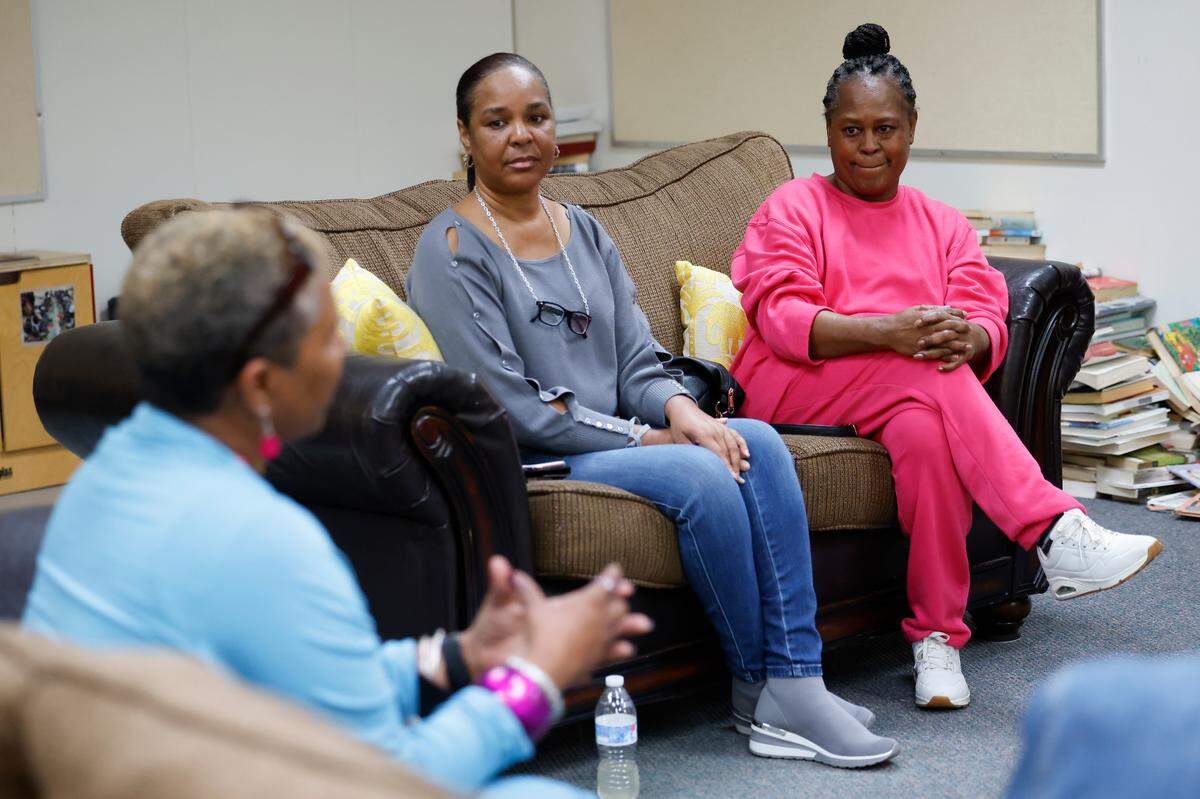 From left, Camille Stephens, Chevelle Jackson, and Terry Stokes, all of Charlotte, take part in a Parent Talk Therapy session at the Plaza Road Academy.