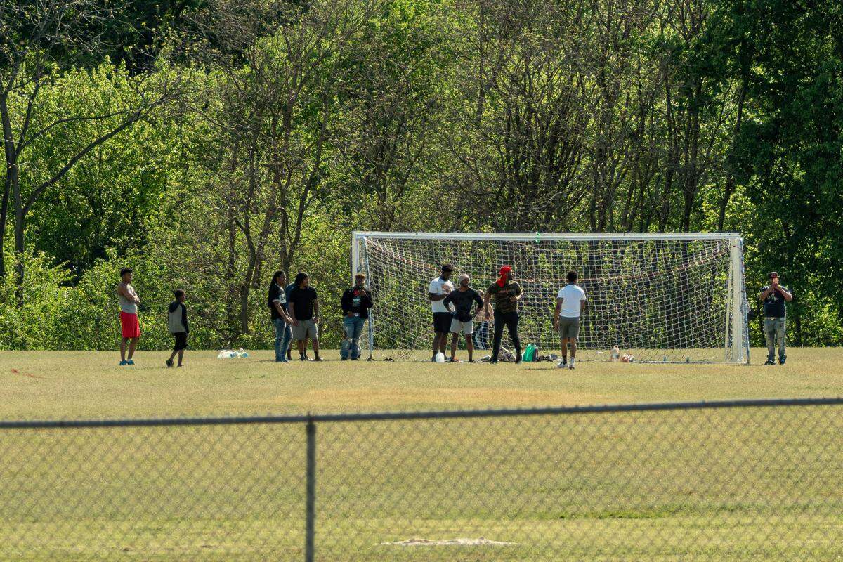 People gather at Southside Park for a match on April 11, 2020, during the COIVD-19 pandemic.