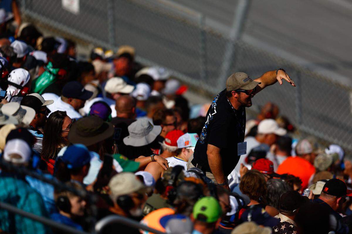 Oct 1, 2023; Talladega, Alabama, USA; A fan reacts to NASCAR Cup Series driver Denny Hamlin (11) during the YellaWood 500 at Talladega Superspeedway.