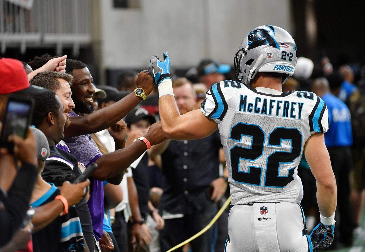 Carolina Panthers running back Christian McCaffrey (22) greets fans before Carolina’s 31-24 loss to Atlanta Sunday. McCaffrey had 14 catches for 102 yards in the game.