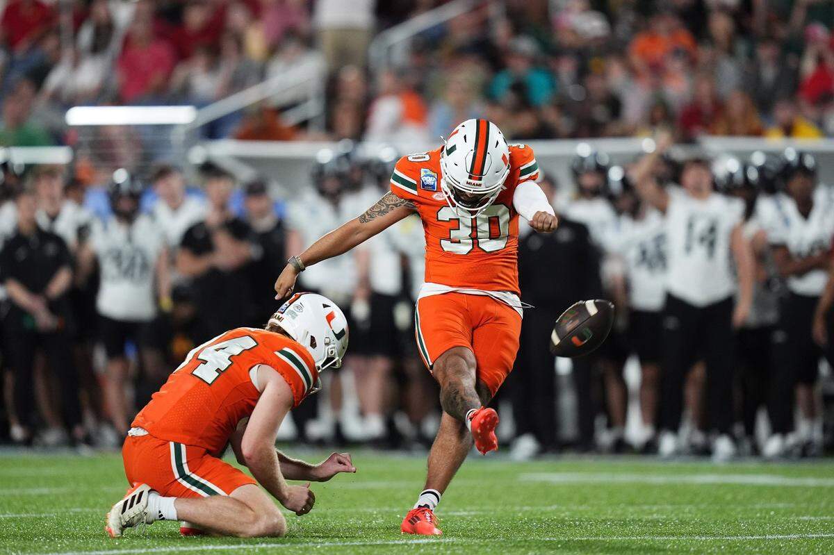 Dec 28, 2024; Orlando, FL, USA; Miami Hurricanes place kicker Andres Borregales (30) kicks an extra point during the second half against the Iowa State Cyclones at Camping World Stadium. Mandatory Credit: Jasen Vinlove-Imagn Images