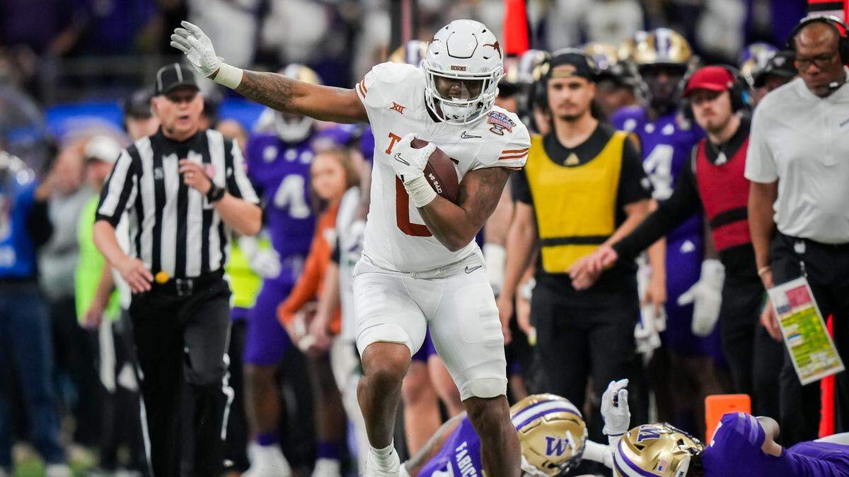 Texas Longhorns tight end Ja’Tavion Sanders evades the Washington Huskies defense during the College Football Playoff semifinals in January in New Orleans. The Huskies won the game over the Texas Longhorns 37-31.
