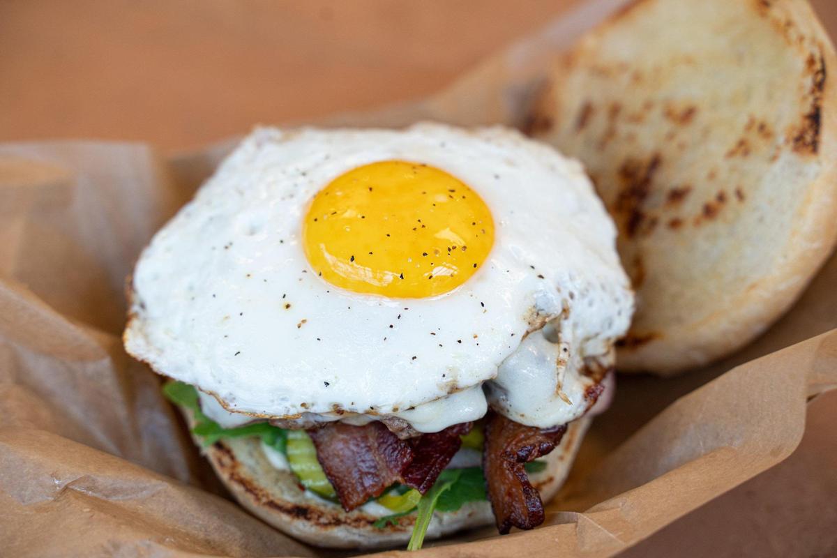 Bleu Barn’s Barn Burger uses local grass-fed beef and is topped with thick apple-wood smoked bacon, local free-range sunny side up egg, mozzarella cheese, house bread and butter pickles, arugula, shaved red onion and roasted garlic aioli. It is part of the new Keswick Avenue food stalls at Camp North End.