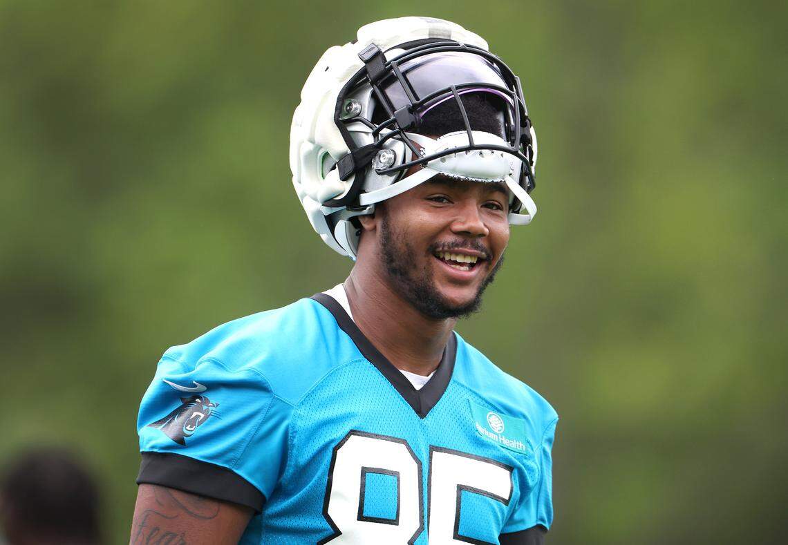 Carolina Panthers tight end Ja’Tavion Sanders smiles as he walks to training camp practice on Thursday, July 25, 2024.