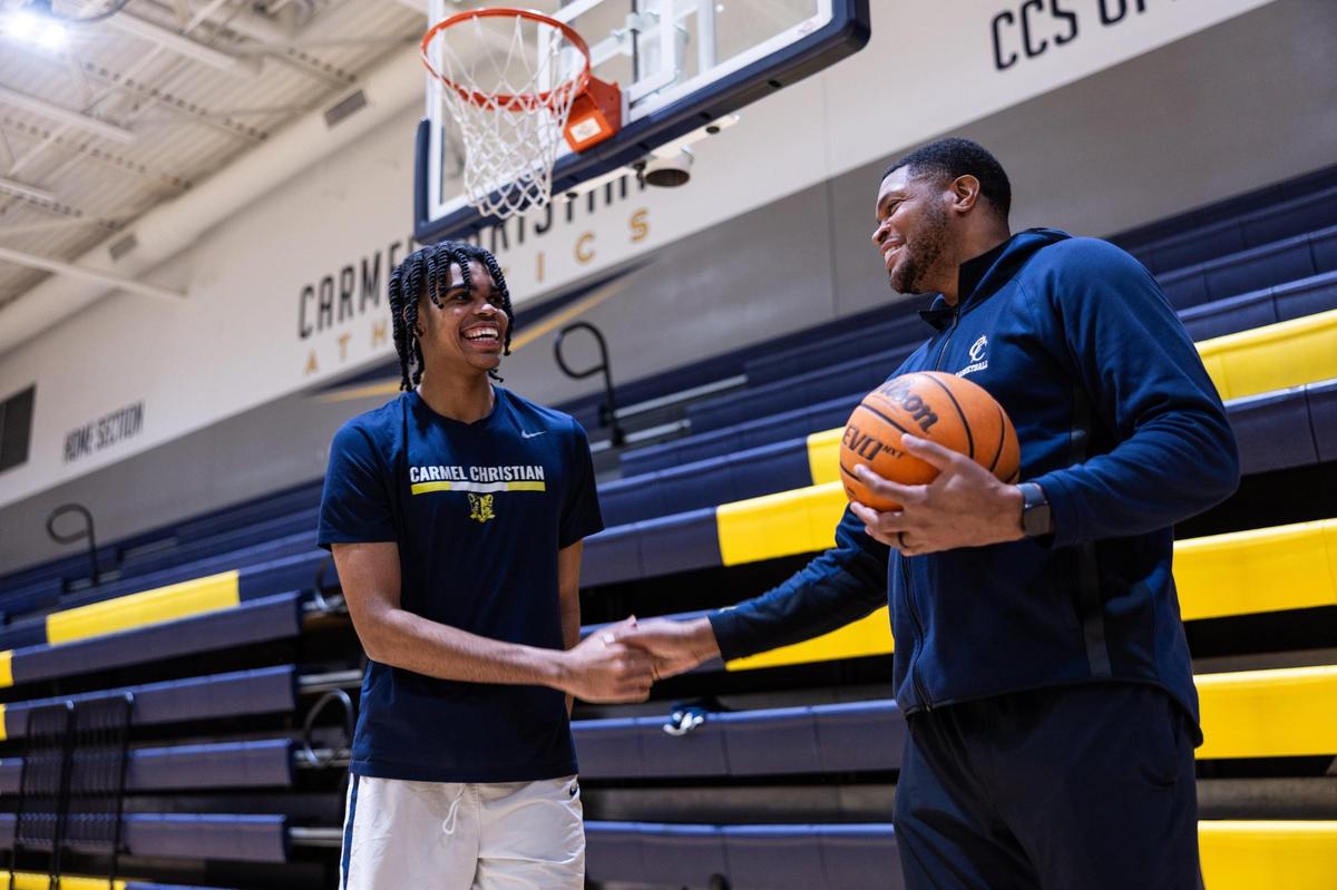 Bryce Slay, left, poses for a portrait with his dad, Tamar Slay at Carmel Christian in Charlotte, N.C., on Monday, December 16, 2024.