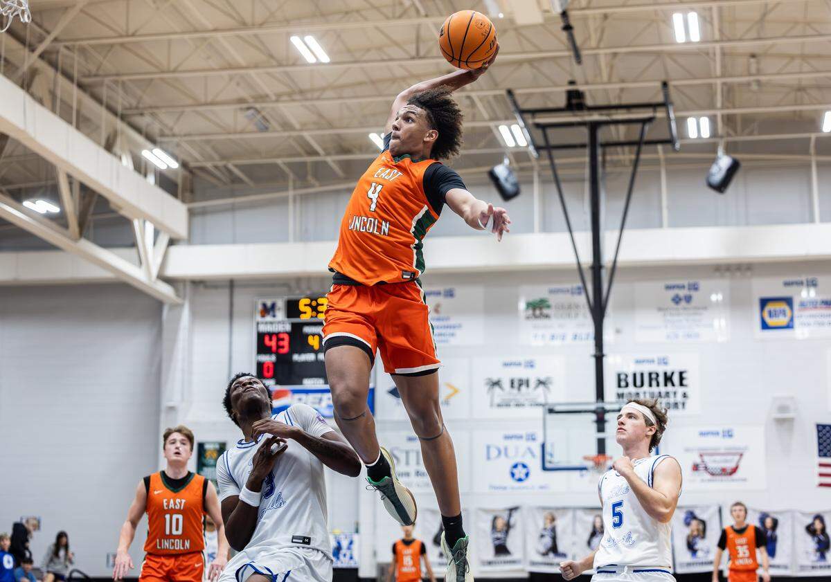 East Lincoln Mustangs Jaxon Dollar, top, dunks past Maiden Blue Devils Tae Maze at Maiden High School in Maiden, N.C., on Monday, January 12, 2025.