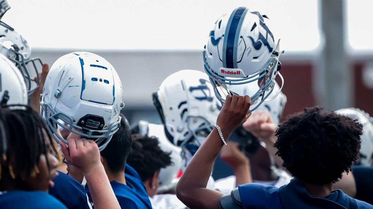 Hickory Ridge chant to signify their unwavering determination and teamwork at the High School football prospect day recruiting showcase at Hickory Ridge High School