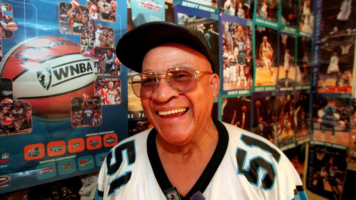 Charlotte Hornets superfan John Jackson, pictured here in 1998, died Monday in his home at age 88.. His home’s walls were not visible through all of the posters and ballcaps he has. He has more than 40 photo albums of pictures of him with famous people at Hornets and Panthers games.