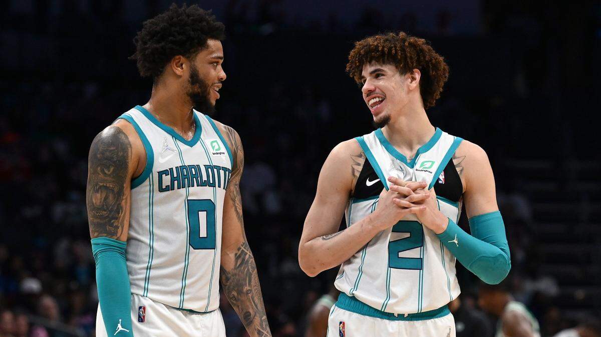 Charlotte Hornets forward forward Miles Bridges, left and guard LaMelo Ball, right, talk during a timeout against the Boston Celtics at Spectrum Center in Charlotte, NC on Wednesday, March 9, 2022.