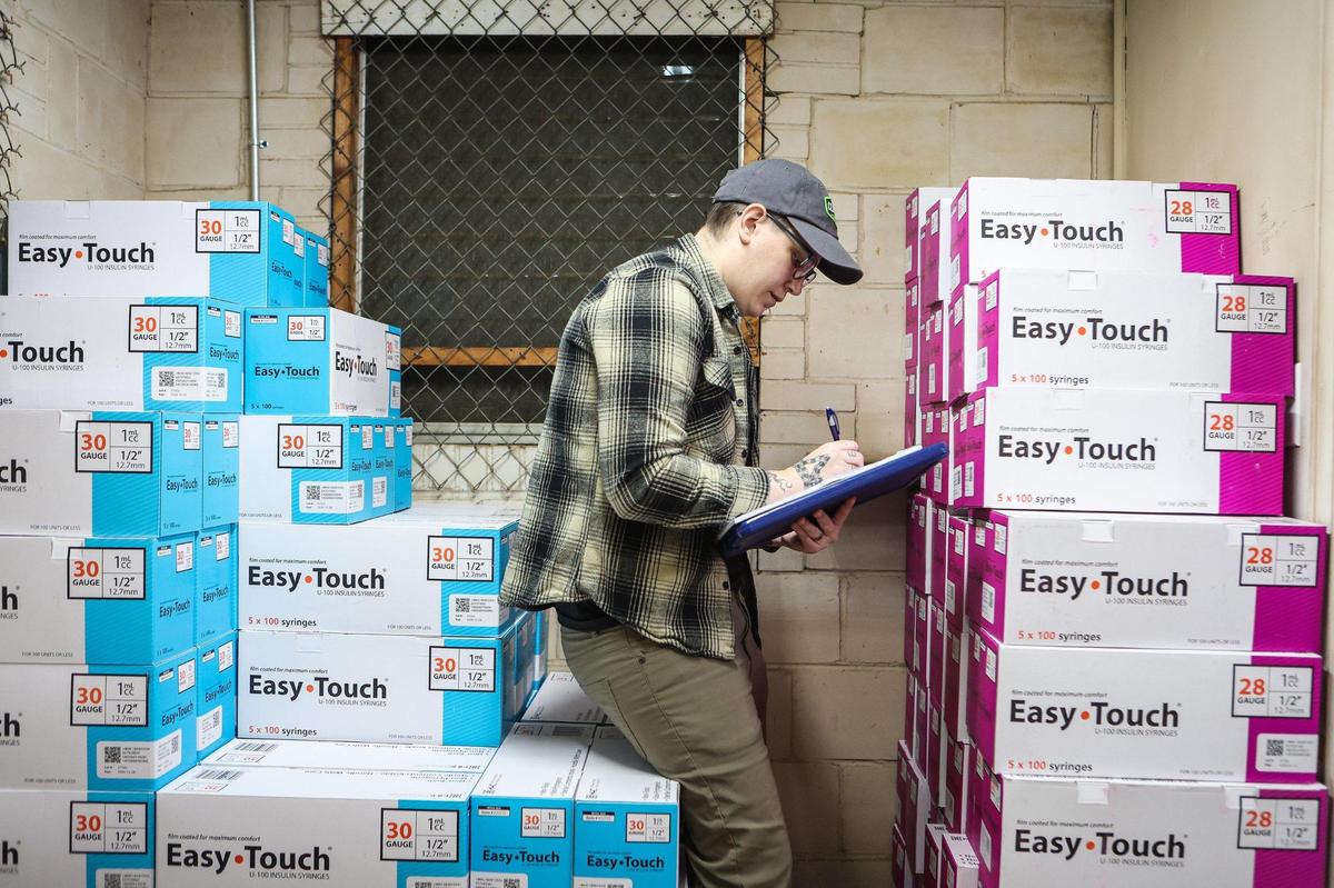 Alexa Crossley takes inventory of syringes at Queen City Harm Reduction on Thursday, November 17, 2022. The organization provides supplies to help prevent people who use drugs from health problems like Hepatitis C, HIV and overdose.