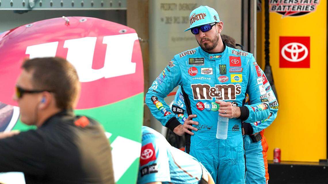 NASCAR driver Kyle Busch watches his team look over his car after he drove into the garage ending his day in the Bank of America ROVAL 400 at Charlotte Motor Speedway on Sept. 29. Busch is one of four drivers with a chance to win the NASCAR championship.