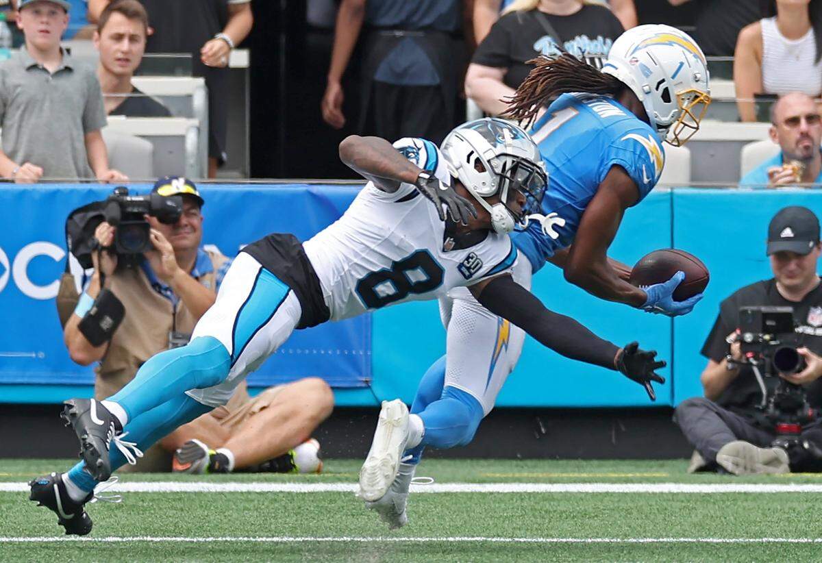 Carolina Panthers cornerback Jaycee Horn, left, is unable to stop Los Angeles Chargers wide receiver Quentin Johnston, right, from catching a touchdown pass during action on Sunday, September 15, 2024 at Bank of America Stadium in Charlotte, NC.