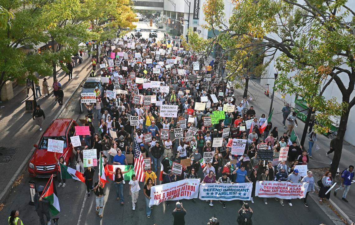 Hundreds of protestors march down North College St. on Saturday, November 15, 2025 in Charlotte, NC. The protestors were participating in the No Border Protest that started at First Ward Park.