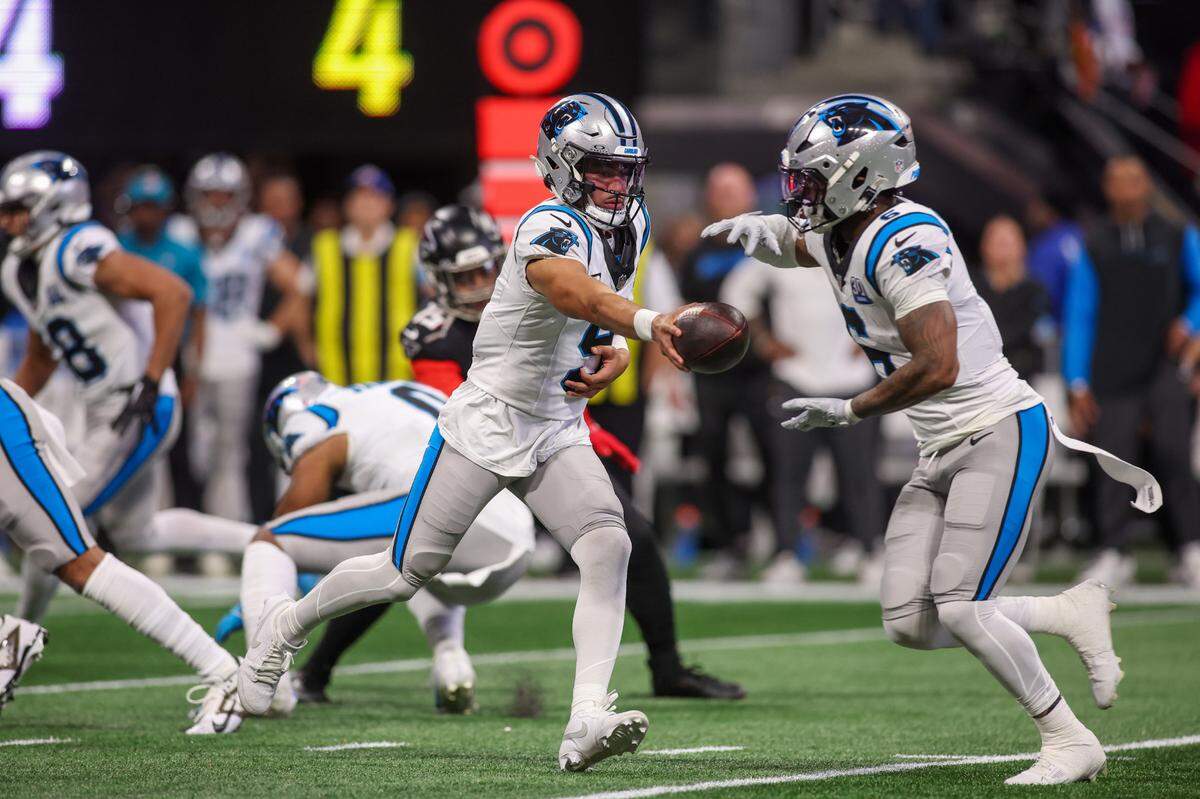 Carolina Panthers quarterback Bryce Young (9) hands the ball off to running back Miles Sanders (6) against the Atlanta Falcons in Sunday’s first quarter at Mercedes-Benz Stadium. Brett Davis-Imagn Images
