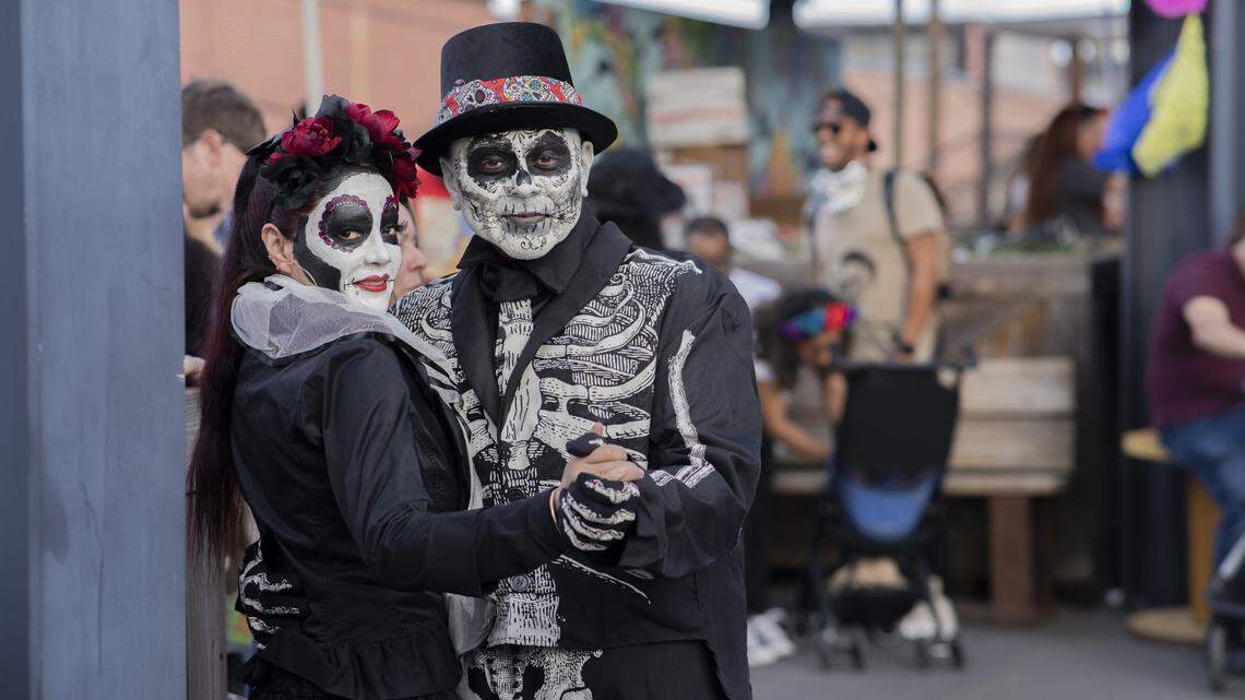 A couple enjoying the Levine Museum of the New South’s free Festival Día de Muertos, the traditional Mexican holiday Day of the Dead.