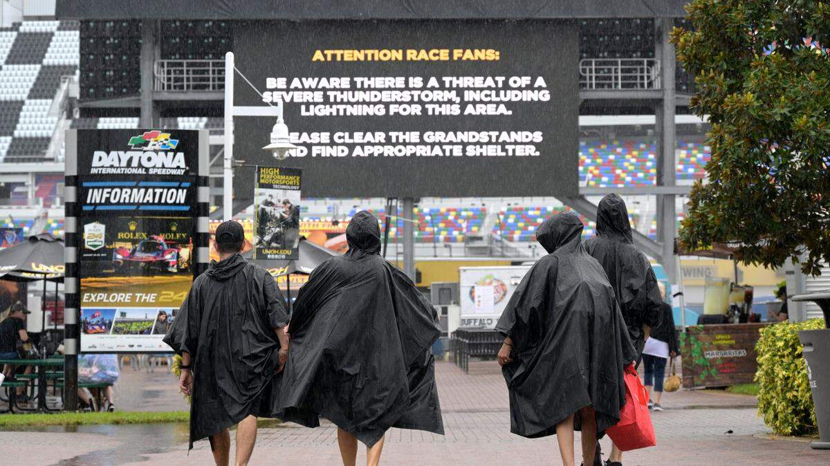 A thunderstorm warning is displayed on an infield monitor as spectators stream into the track before a NASCAR Cup Series auto race at Daytona International Speedway, Saturday, Aug. 27, 2022, in Daytona Beach, Fla. (AP Photo/Phelan M. Ebenhack)