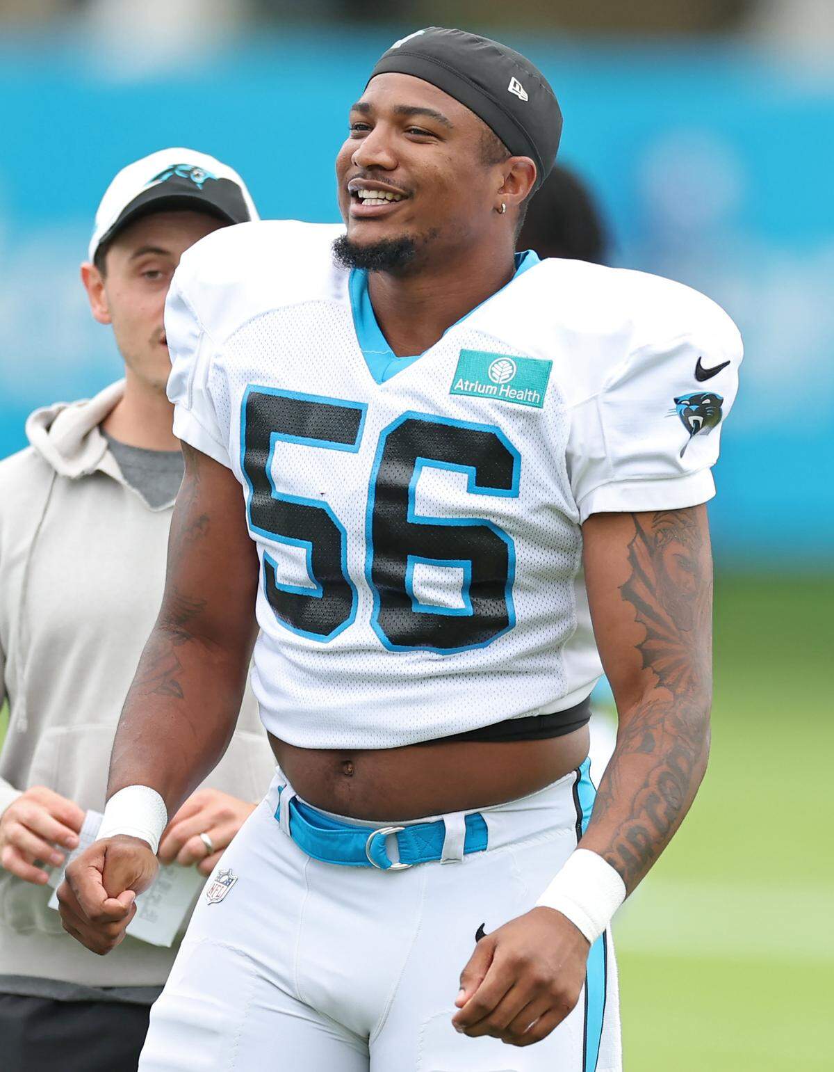 Carolina Panthers linebacker Trevin Wallace jokes with his teammates prior to practice on Tuesday, August 6, 2024.