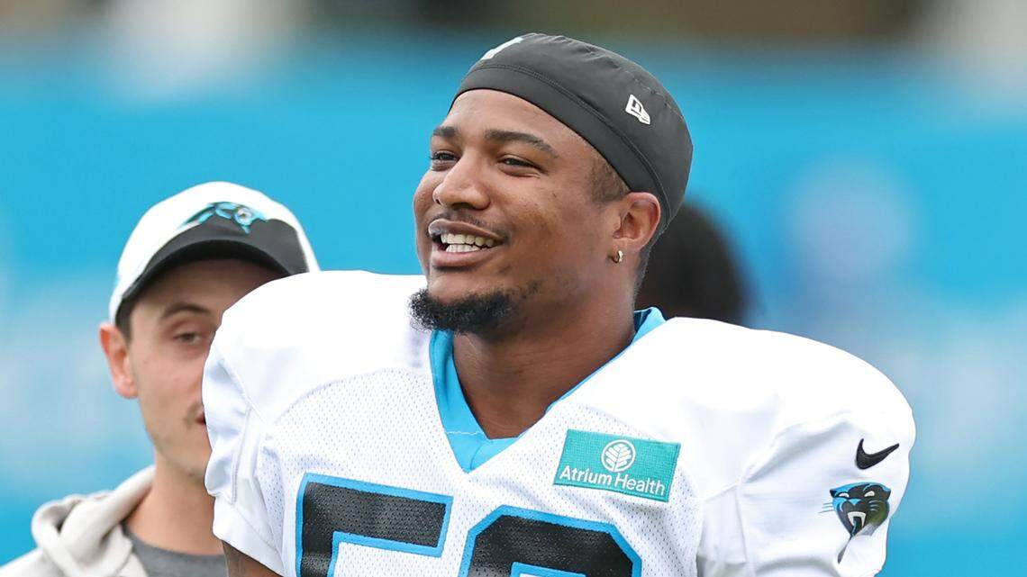 Carolina Panthers linebacker Trevin Wallace jokes with his teammates prior to practice on Tuesday, August 6, 2024.