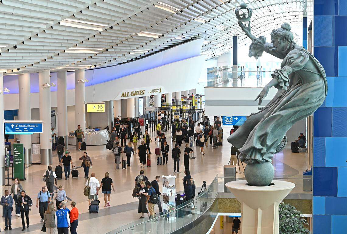 Travelers pass through the lobby area of Charlotte Douglas International Airport in Charlotte, on Wednesday, Sept. 17, 2025. 