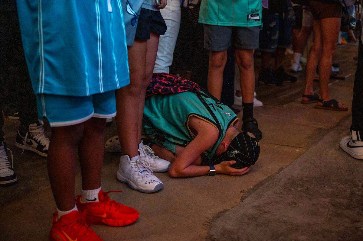 Charlotte Hornets fan Gray Gregory sinks to the floor after the team selects Kon Knueppel during Wednesday’s NBA Draft.