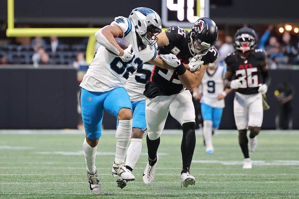 Carolina Panthers TE Tommy Tremble runs the ball after a catch against Atlanta Falcons LB Kaden Elliss during Sunday’s fourth quarter at Mercedes-Benz Stadium in Atlanta. 