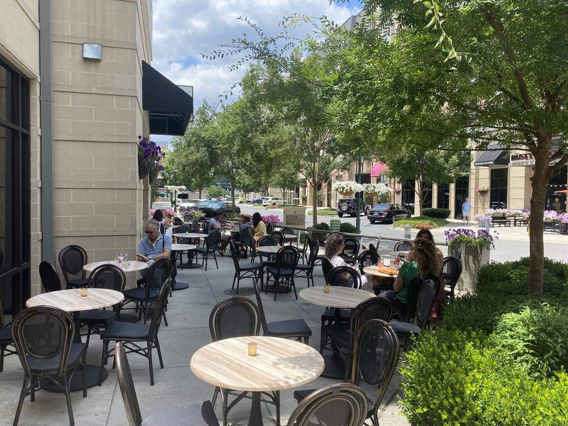 The Dilworth Tasting Room has an elegant patio surrounded by greenery.