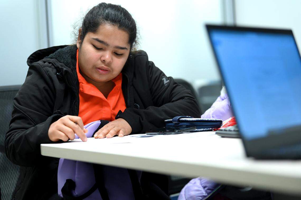 Erika Salamanca looks over paperwork while working with a supervising attorney at the Charlotte Center for Legal Advocacy on Friday, November 11, 2022. Charlotte Center for Legal Advocacy was holding a pro-se asylum clinic to help an increasing number of pre-selected asylum seekers.