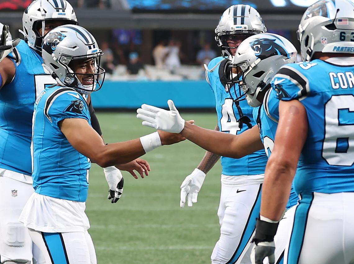 Carolina Panthers quarterback Bryce Young, left, reaches out to congratulate wide receiver Jalen Coker, right, following Coker's touchdown pass reception during action against the Cleveland Browns on Friday at Bank of America Stadium.