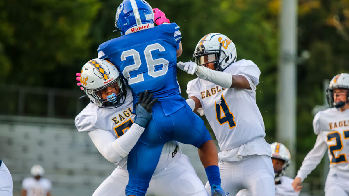 East Meck defense defends their kicker after they score the first touchdown of the game