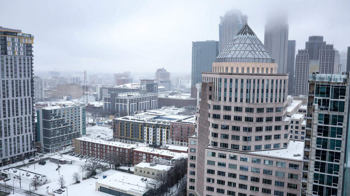 A mix of snow and sleet blanketed Uptown Charlotte on Sunday. The ice is beginning to melt but may refreeze Monday night when temperatures drop to 11 degrees.
