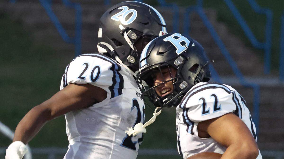 Hough Huskies Jeremiah Jones, left, congratulates running back Jycen Anciso, right, on his touchdown run against the North Meck Vikings on Thursday, September 14, 2023 at North Meck High School.