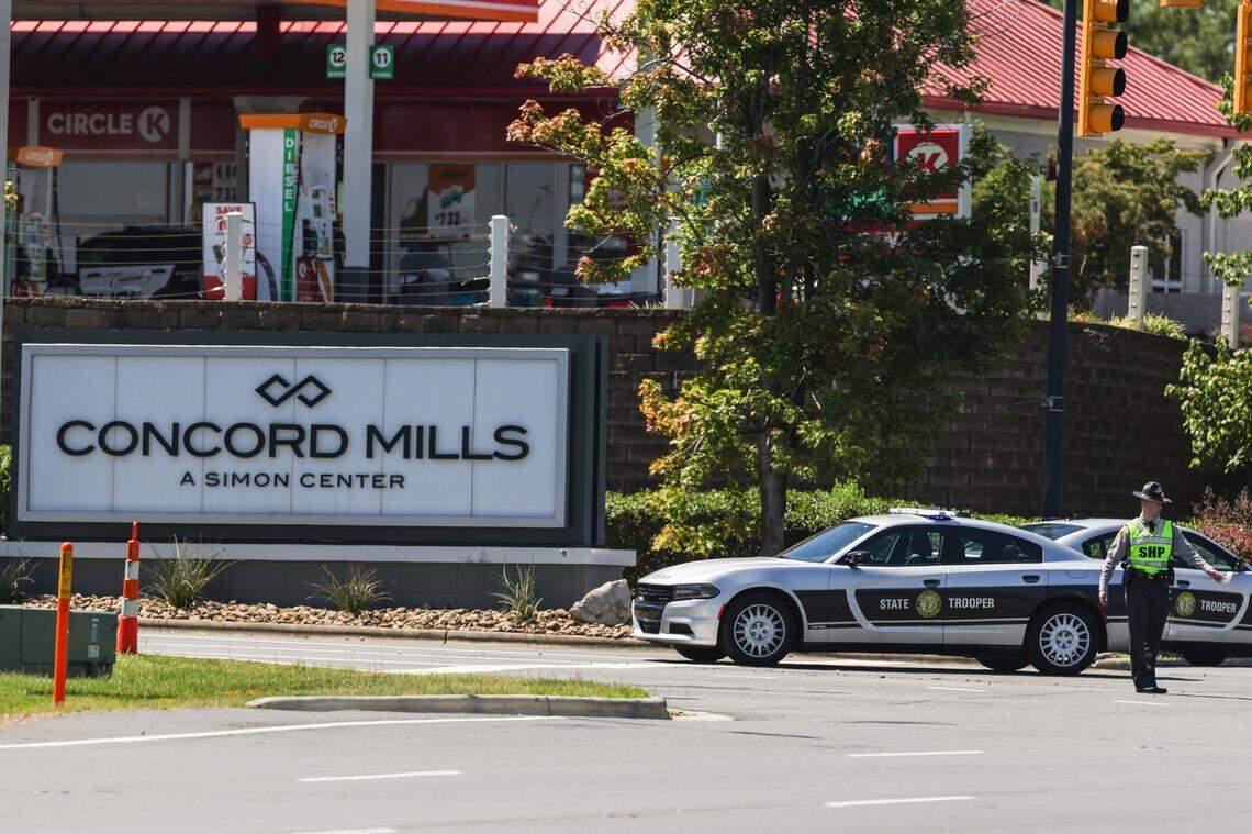 A North Carolina State Highway Patrol trooper stands watch near an entrance to Concord Mills on Wednesday, August 31, 2022. Concord police officers shot and injured a suspect, forcing the mall to close.